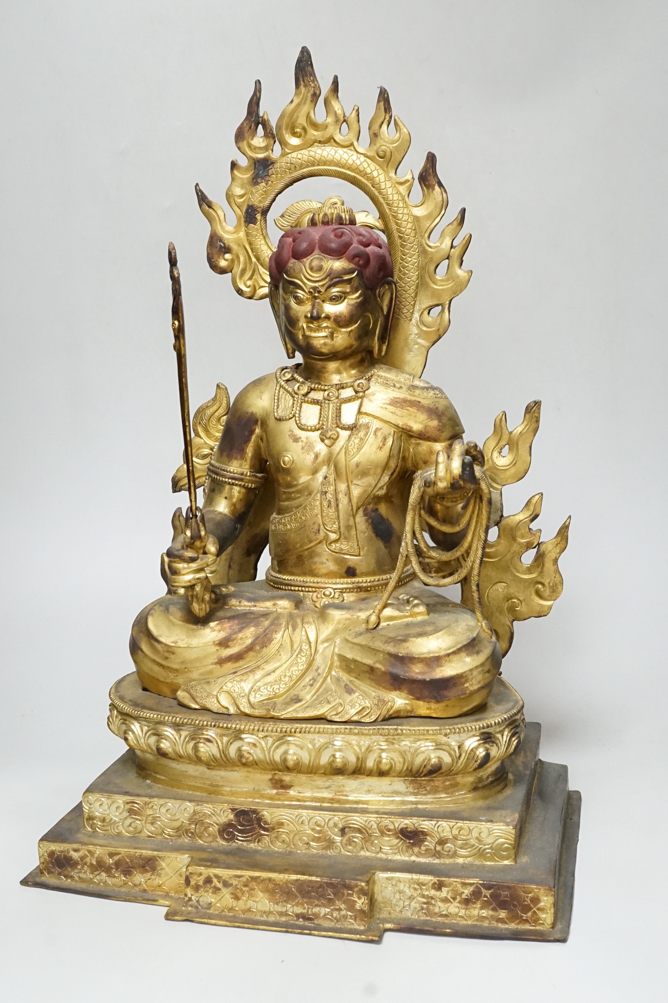 A large Sino-Tibetan gilt bronze figure of Fudo Myob (Acala), 44cm high